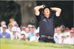  ?? Darron Cummings / Associated Press ?? Phil Mickelson reacts after hitting out of a bunker on the second hole during the fourth round of the U.S. Open golf tournament at Merion Golf Club in Ardmore, Pa. on June 16, 2013.