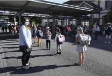  ?? Frederick Florin, AFP/Getty Images ?? Children line up to enter their classrooms at an elementary school in Strasbourg, eastern France, on Monday as primary and middle schools there reopened.