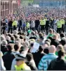  ??  ?? TENSIONS: Police keep rival fans apart at an Old Firm match.