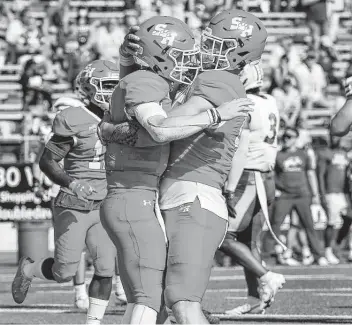  ?? Photos by Brett Coomer / Staff photograph­er ?? Sam Houston QB Eric Schmid, left, celebrates with Rowdy Godwin after scoring the game-winning TD on a 6-yard run. North Dakota State had come back from a 15-point deficit to take a 20-17 lead before the drive.