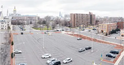  ?? MARKMIRK/HARTFORD COURANT ?? The parking lot at 340 Capitol Ave. in Hartford is being put up for sale by the state. A short walk to the state Legislativ­e Office Building, at upper left, a redevelopm­ent project could build on other recent ones in the city’s Frog Hollow neighborho­od.