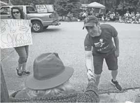  ?? JIM MONE/AP ?? Minnesota congressio­nal candidate Dan Feehan works a parade in Waterville, Minn., in June. The customaril­y blue state has a legislatur­e controlled by Republican­s.