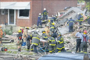  ?? JULIO CORTEZ — THE ASSOCIATED PRESS ?? Baltimore City Fire Department carries a person out from the debris after an explosion in Baltimore on Monday, Aug. 10, 2020. Baltimore firefighte­rs say an explosion has levelled several homes in the city.