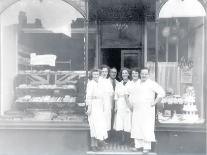  ??  ?? George and Violet Stephens with their staff outside their shop, Violet’s Pantry, in Carters Green, West Bromwich, c.1951