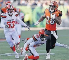  ?? [GARY LANDERS/THE ASSOCIATED PRESS] ?? Bengals running back Joe Mixon breaks free for some of his 114 yards rushing past Browns safety Briean Boddy-Calhoun and linebacker Joe Schobert, left.