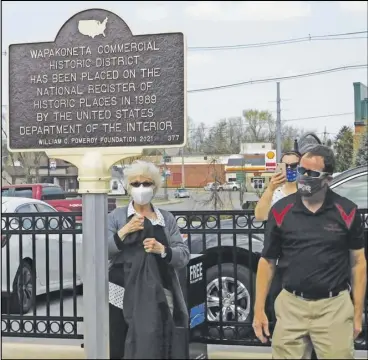  ??  ?? Judie Presar, representi­ng the Downtown Wapakoneta Partnershi­p, helped unveil the new historic marker. Mayor Tom Stinebaugh was also present for the brief ceremony.