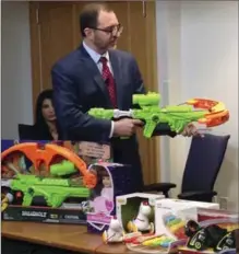  ?? PHILIP MARCELO, THE ASSOCIATED PRESS ?? James Swartz, director of World Against Toys Causing Harm, displays Nerf’s "Zombie Strike" crossbow, one of its top 10 worst toys, during a news conference in Boston on Tuesday.