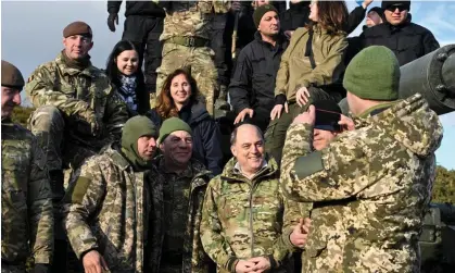  ?? ?? Ukrainian personnel take pictures with Ben Wallace during training in the UK on Wednesday. Photograph: Toby Melville/Reuters