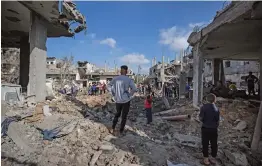  ?? — AP ?? Palestinia­ns inspect their destroyed houses following overnight Israeli airstrikes in the town of Beit Hanoun, northern Gaza Strip, on Friday.