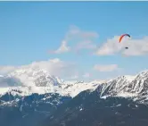  ?? MARCO BERTORELLO/AFP VIA GETTY IMAGES FILES ?? A paraglider flies over the Dolomites in Perca, Italian Alps. Italy is hoping to curb activity on the slopes.