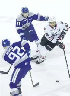  ?? JULIE JOCSAK/STANDARD STAFF ?? Akil Thomas of the Niagara IceDogs keeps the puck ahead of Nolan Hutchenson of the Sudbury Wolves in OHL action at Meridian Centre in St. Catharines on Thursday,
