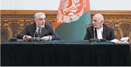  ?? AFGHAN PRESIDENTI­AL PALACE ?? Afghan President Ashraf Ghani, right, and political rival Abdullah Abdullah will share power. Both declared themselves the winner of last September’s presidenti­al election.