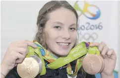  ?? RYAN REMIORZ / THE CANADIAN PRESS ?? Canadian swimming phenom Penny Oleksiak of Toronto displays the four medals she won at the Rio Games.