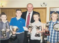  ??  ?? South Cliff junior award winners, from left Jasmine Smalley, Tommy Risker, Amy Staveley and Sean Burrows show off their silverware with coach Ivan Oliver