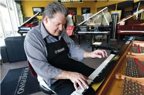  ?? Kim Brent/The Beaumont Enterprise via AP ?? ■ Robert Zoschke works on tuning and repairing a piano April 21, 2017, at The Piano Center in Beaumont, Texas. Zoschke learned the trade from his late father, Marvin Zoschke, who started the piano sales and repair store in the 1950s. He is now the only...