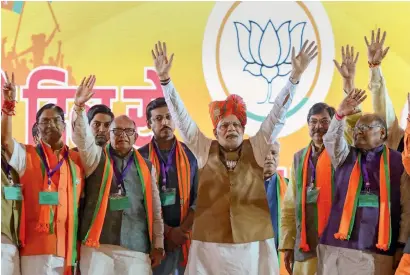  ?? PTI ?? Prime Minister Narendra Modi raises his arms along with BJP candidates at an election campaign rally ahead of the state Assembly elections in Jaipur, Rajasthan, on Tuesday. —