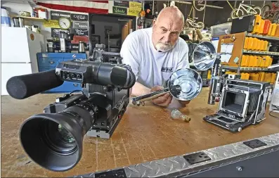  ??  ?? Property Master Dick Kyker of Studio Props prepares prop cameras for an upcoming shoot. The filming industry was initially hit hard by COVID-19, but it started up again with new guidelines. PHOTO BY DAN WATSON / THE SIGNAL