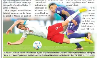  ?? AFP PHOTO ?? Poland’s forward Robert Lewandowsk­i (9) and Argentina’s defender Cristian Romero fight for the ball during the Qatar 2022 World Cup Group C football match at Stadium 974 in Doha on Wednesday, Nov. 30, 2022.