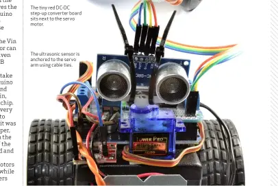  ??  ?? The tiny red DC-DC step-up converter board sits next to the servo motor. The ultrasonic sensor is anchored to the servo arm using cable ties.