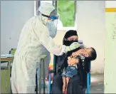  ?? RAJ K RAJ/HT PHOTO ?? A health worker collects a child’s swab sample. n