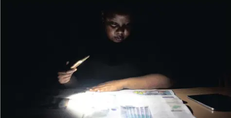  ??  ?? Eskom was set to continue with the implementa­tion of stage 4 load shedding today. The outages are expected to continue all of this week. Here journalist Sibongile Mashaba is seen working in The Star’s Joburg offices with the light of her cellphone. | NHLANHLA PHILLIPS African News Agency (ANA)