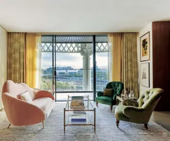  ??  ?? From left Bold colour and a mix of styles bring warmth to a new-build flat; paintings from the couple’s extensive art collection are displayed on a pink hessian wallcoveri­ng in the dining area; the main bedroom, with a mid-century bedside table