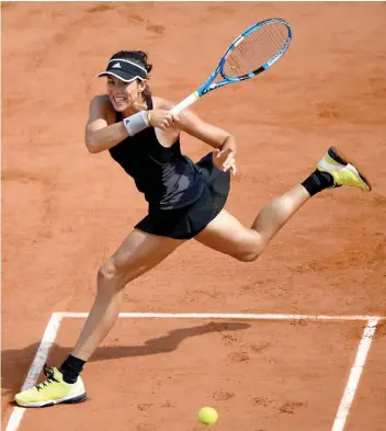  ?? AFP ?? Garbine Muguruza of Spain plays a forehand return to Fiona Ferro of France during their women’s singles second round match in the French Open at Roland Garros in Paris on Thursday. Muguruza won 6- 4, 6- 3. —