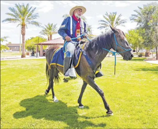  ?? Michael Blackshire Las Vegas Review-Journal ?? Keith Hill, president trooper of the 9th and 10th Horse Cavalry Associatio­n, rides his horse during Buffalo Soldiers Day at the Doolittle Senior Center on Saturday.
