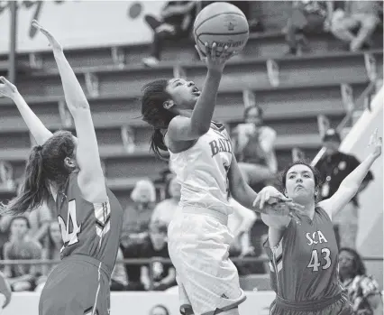  ?? STAFF PHOTOS BY ERIN O. SMITH ?? Baylor’s Raegyn Conley puts up a shot between St. Cecilia’s Sarah Davis, left, and Danielle Meacham on Tuesday at Baylor School. Baylor rolled to a 66-32 victory victory in the first round of the Division II-AA state tournament.