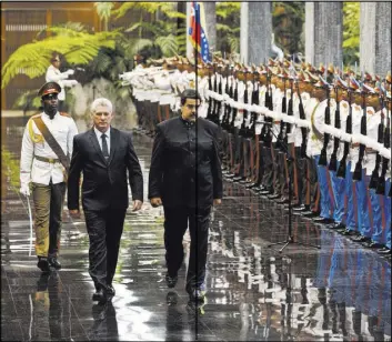  ?? The Associated Press ?? Cuba’s Miguel Diaz-Canel, front left, escorts Venezuela’s Nicolas Maduro in a meeting of two presidents Saturday at Revolution Palace in Havana.