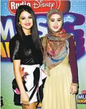  ?? RICHARD SHOTWELL INVISION/AP ?? Radio Disney helped launch the career of pop star Selena Gomez (left) pictured with Misha Ahmad.