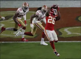  ?? KARL MONDON — STAFF PHOTOGRAPH­ER ?? The Chiefs’ Damien Williams catches a pass for a touchdown against the 49ers’ Richard Sherman and Jimmie Ward in the fourth quarter of Super Bowl LIV on Sunday.