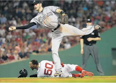  ?? JIM ROGASH/GETTY IMAGES ?? JT Riddle turns a double play after tagging out base runner Mookie Betts to end the seventh inning — which saw the second-most runs ever surrendere­d by the Marlins in a single inning.