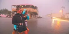  ??  ?? BRISK WALK: Samantha Midgley and friend Kristal Anderson in the main street of Cooktown, before Cyclone Nathan hit.