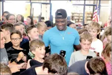  ?? LYNN KUTTER ENTERPRISE-LEADER ?? Sixth-graders at Lynch Middle School in Farmington gather around Olympic hurdler Omar McLeod for group photos and selfies. McLeod won the gold medal for the 110-meter hurdles, running for Jamaica. He also ran hurdles for the University of Arkansas.