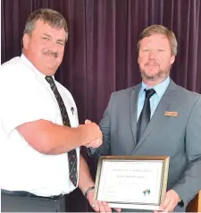  ??  ?? Point High School headmaster, Adolf Gouws, receives a certificat­e of merit from deputy mayor Dirk Kotzé.