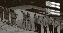  ?? Karen Warren / Staff photograph­er ?? The Rockets stand on the court for the national anthem before the start of a game at Toyota Center last week.