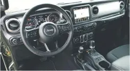  ??  ?? Inside the 2021 Jeep Wrangler 80th Anniversar­y edition, well equipped with the UConnect 4C system with Android Auto, Apple CarPlay, Nav & Sound Group. Interior cues include an Annodized Gunmetal instrument panel and Light Tungsten accents.