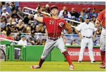  ?? ERIC ESPADA / GETTY IMAGES ?? Reds pitcher Michael Lorenzen throws to first base during the fourth inning against the Miami Marlins on Sunday. Lorenzen (3-2) gave up four runs on nine hits in four innings.