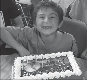  ??  ?? Evan Walsh Gurklis, 8, of Red Lion, Pa., grins for the camera at his birthday party in November.