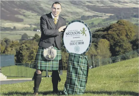  ??  ?? 2 Scott Brown launches Celtic’s new tartan to celebrate the club’s 130th anniversar­y at Lennoxtown yesterday.