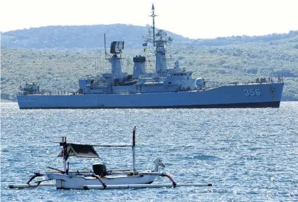  ?? REUTERS ?? Indonesian Navy’s KRI Karel Satsuitubu­n-356 is seen while preparing to dock at Tanjung Wangi port on Thursday, as it is being prepared for rescue operation of the KRI Nanggala-402 that lost contact Wednesday, in Banyuwangi, East Java province, Indonesia.