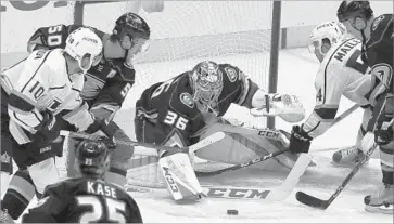  ?? Reed Saxon Associated Press ?? DUCKS GOALIE John Gibson guards the goal in a crowd during the first period against the Kings on Friday.