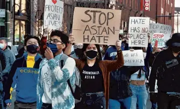  ?? CHRIS SWEDA/CHICAGO TRIBUNE ?? Citizens rally against Asian hate during a march and protest in Chicago’s Logan Square neighborho­od Saturday.