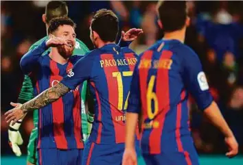  ?? AFP ?? Barcelona’s forward Paco Alcacer (right) celebrates with Barca star Lionel Messi after scoring against Sporting de Gijon at the Camp Nou on Wednesday. Barcelona won 6-1.