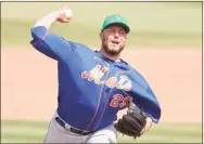  ?? Michael Reaves / Getty Images ?? Tommy Hunter of the New York Mets delivers a pitch against the Miami Marlins during the seventh inning of a Grapefruit League spring training game at Roger Dean Stadium on March 17 in Jupiter, Fla. Hunter was released from his minor-league contract with the Mets on Thursday.