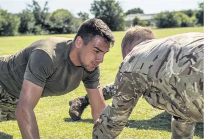  ?? Corporal Ben Beale ?? Accrington Stanley football players (green t-shirts) partake in battle PT with 1RLC, St David’s Barracks.