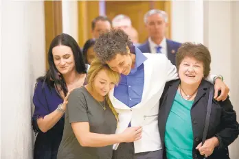  ?? MARK MAKELA/AP FILE PHOTO ?? Bill Cosby accuser Andrea Constand, center, and supporters embrace after Cosby was found guilty in his sexual assault retrial in April 2018 at the Montgomery County Courthouse in Norristown. A Pennsylvan­ia appeals court will hear arguments Monday as Cosby appeals his conviction.