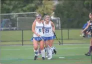  ?? THOMAS NASH - DIGITAL FIRST MEDIA ?? Mackenzie Hilditch (6) celebrates with Katie Podell (21) after scoring a goal during Thursday’s district playoff game against Phoenixvil­le.