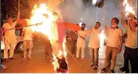  ?? ?? Protestors burn an effigy of Yogi Adityanath, Chief Minister of the northern state of Uttar Pradesh, during a protest after people were killed when a car linked to a federal minister ran over farmers protesting against controvers­ial farm laws (Reuters)